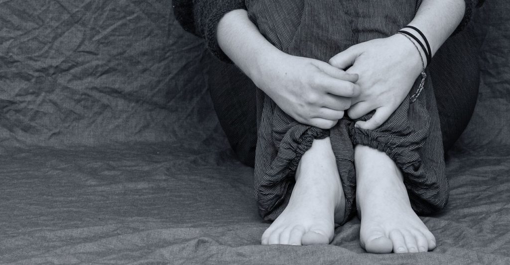depressed young girl's hands and legs