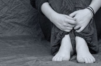 depressed young girl's hands and legs