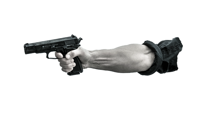 Picture of a man's arm extended pointing an semi-automatic hand gun