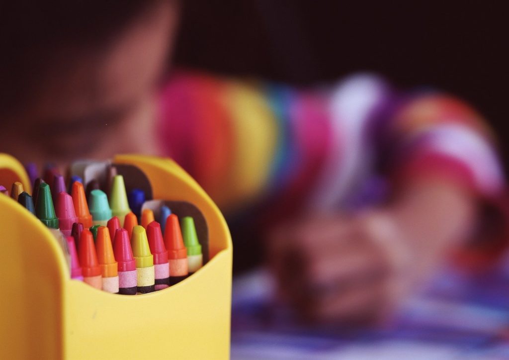 Child drawing with crayons.