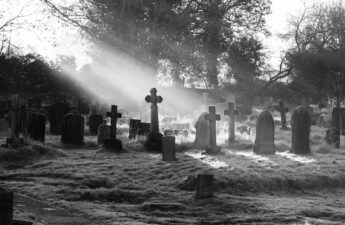 Black and white photo of a graveyard.