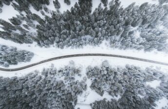 Highway through snow bound forest winter Photo by Kimon Maritz on Unsplash