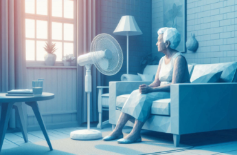 Illustration of an elderly woman sitting in front of a fan in a living room on a hot day.